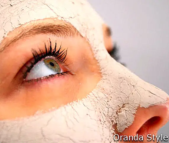 Primo piano di una maschera di argilla spa sul volto di una donna