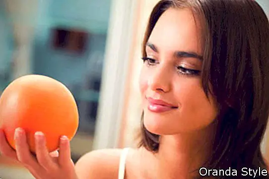 Krásná brunetka při pohledu na Grapefruit