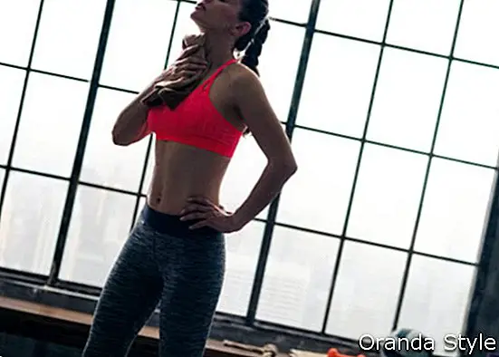 Eine Frau wischt sich nach einem tollen Training den verdienten Schweiß vom Nacken