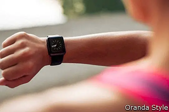 Nærbillede af ung kvinde, der kontrollerer tiden på smartwatch-enheden efter jog