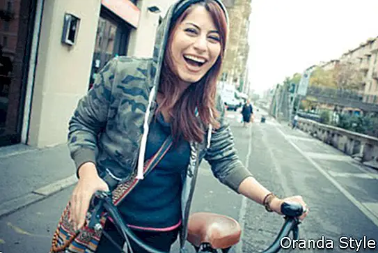 prekrasan ženski bicikl s crvenom glavom u gradu